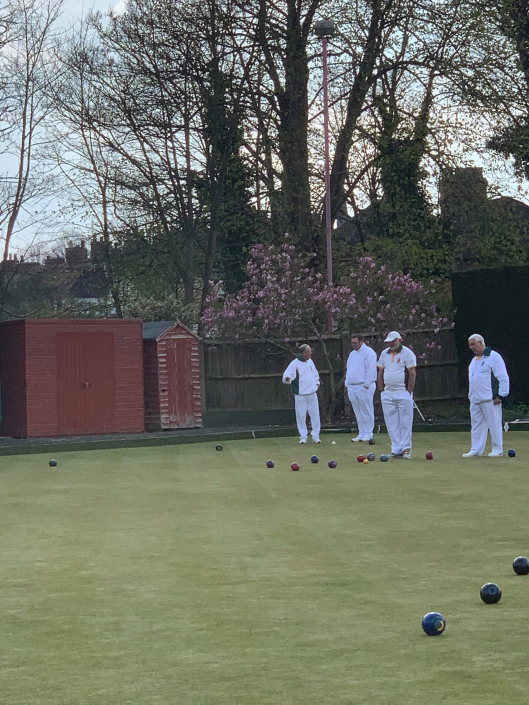 a group of bowlers looking at the game